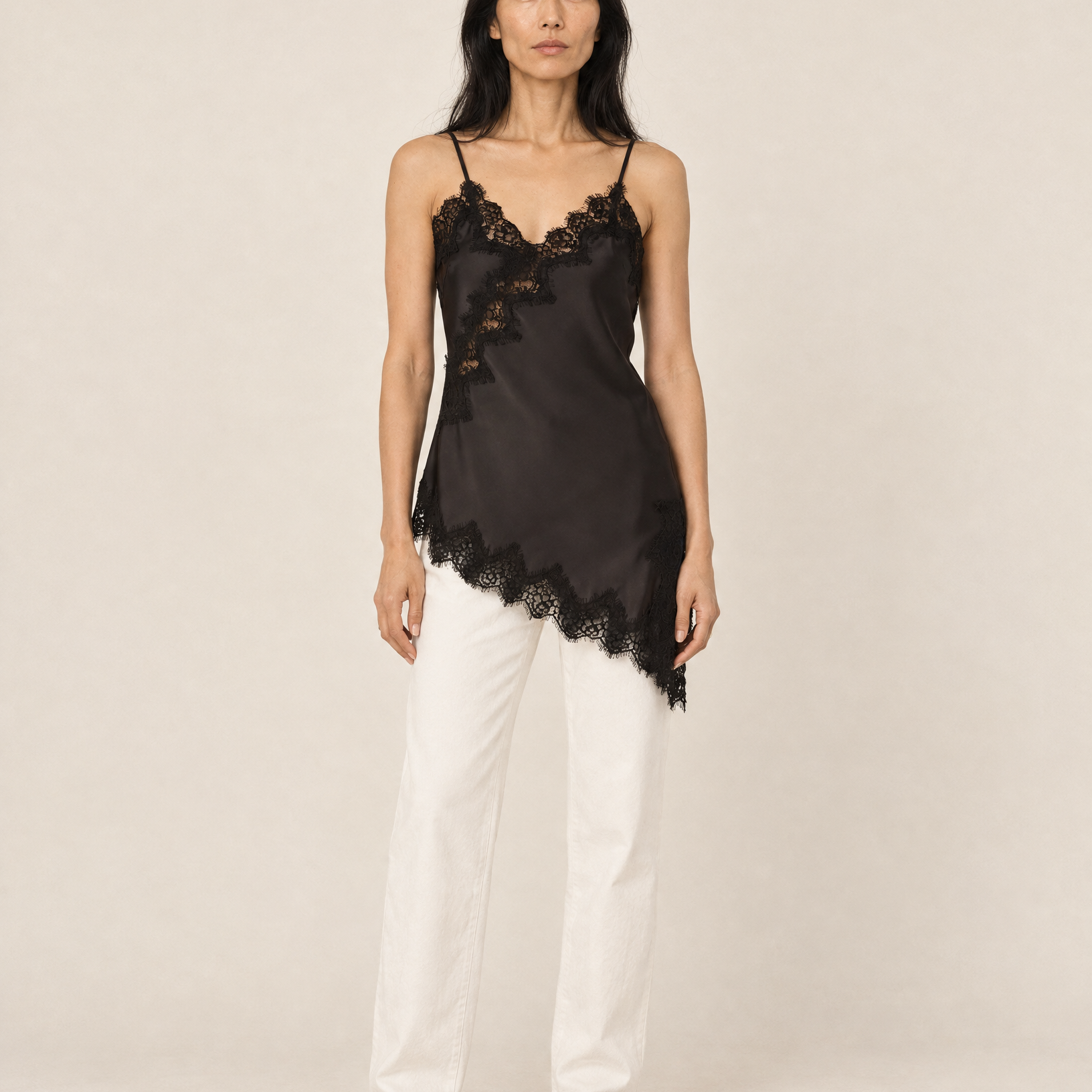 Generated_with_Kive.ai_-_Black_Asymmetrical_Lace_Trim_Cami_styled_with_white_straight_leg_trousers_with_no_pleating_with_black_loafers_in_Muted_Gallery_on_Mina.png