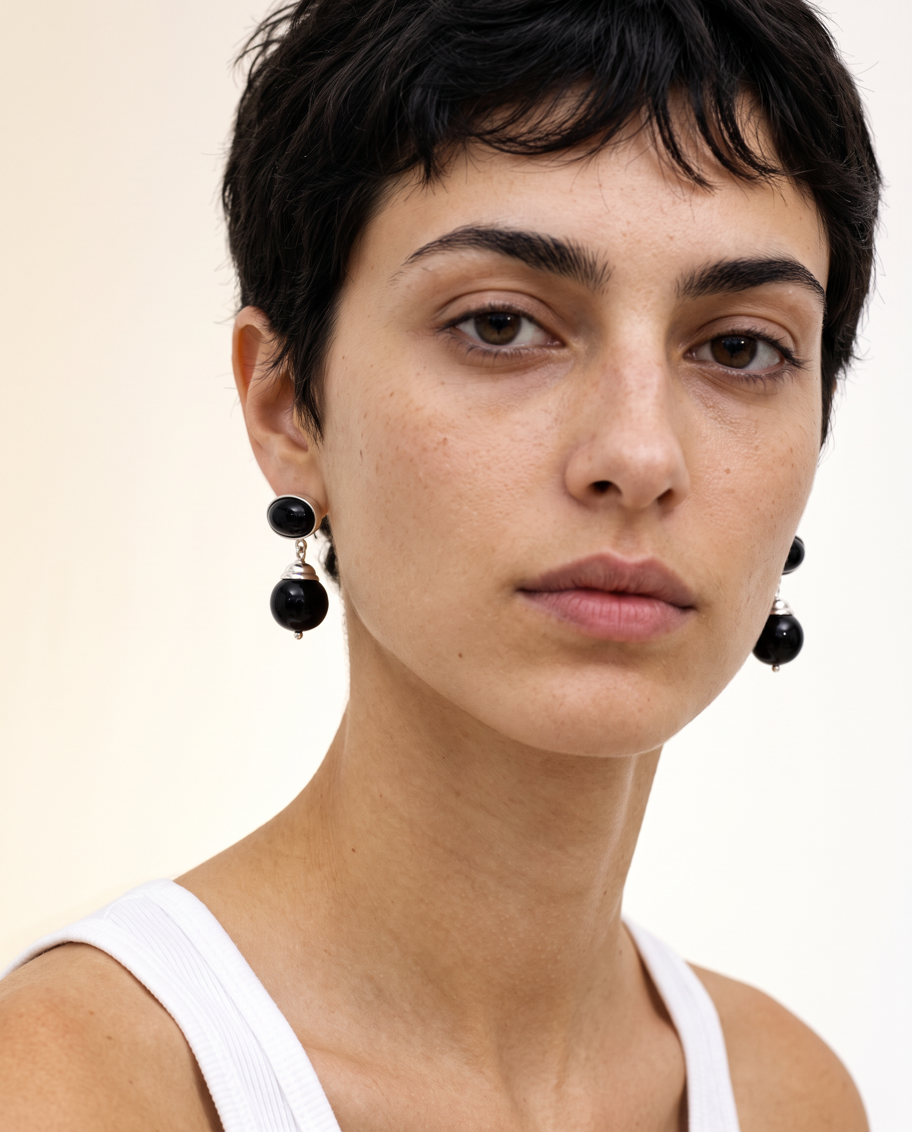 Generated_with_Kive.ai_-_place_Maslo_Black_Onyx_Marceau_Earrings_on_Ines_in_Beauty_Roll_close_up_of_detail_on_earrings.png